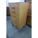 A teak chest of drawers