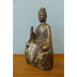 An oriental bronze figure of a seated deity
