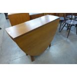 A teak drop-leaf table