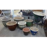 Eight glazed terracotta plant pots