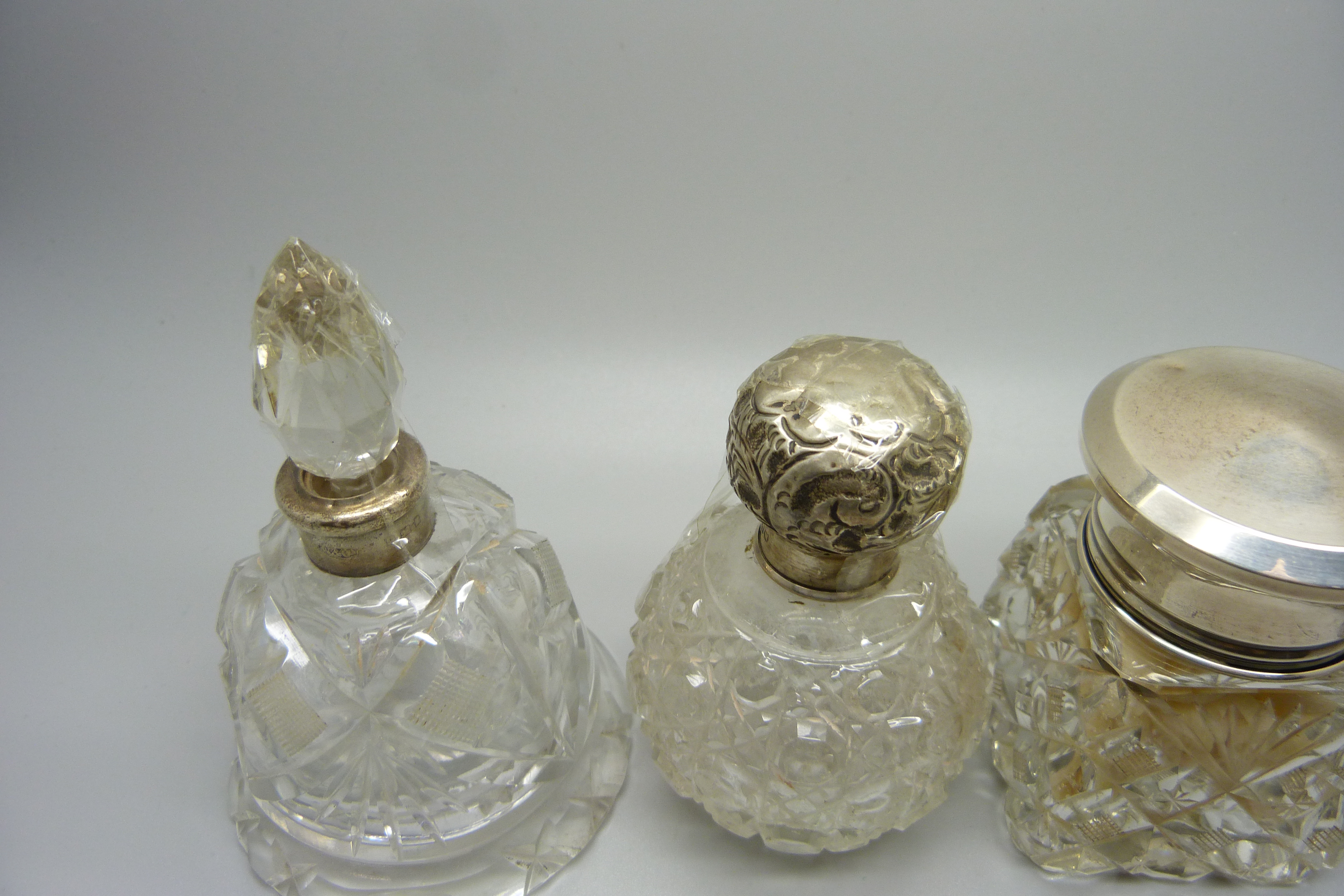 Four silver topped glass scent bottles/dressing table pots, including a scent bottle in the shape of - Image 2 of 3
