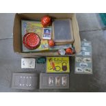 A collection of 1950's toys, includes a child's polka dot tea set, chalk board, Happy Families