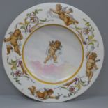 A 19th Century dish decorated with cherubs, 32.5cm