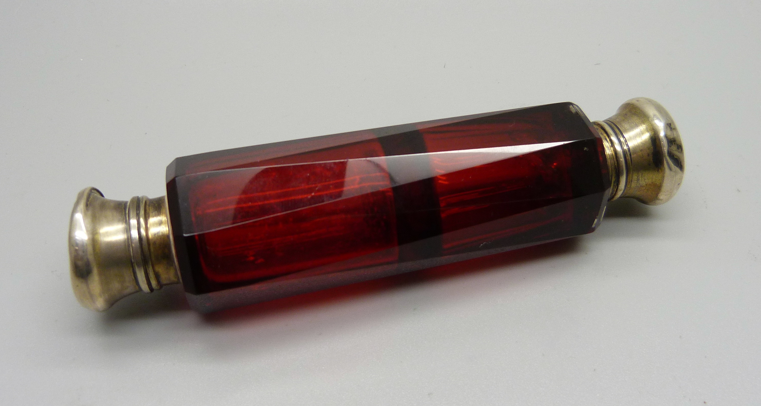 A ruby glass double scent bottle, (tops dented)