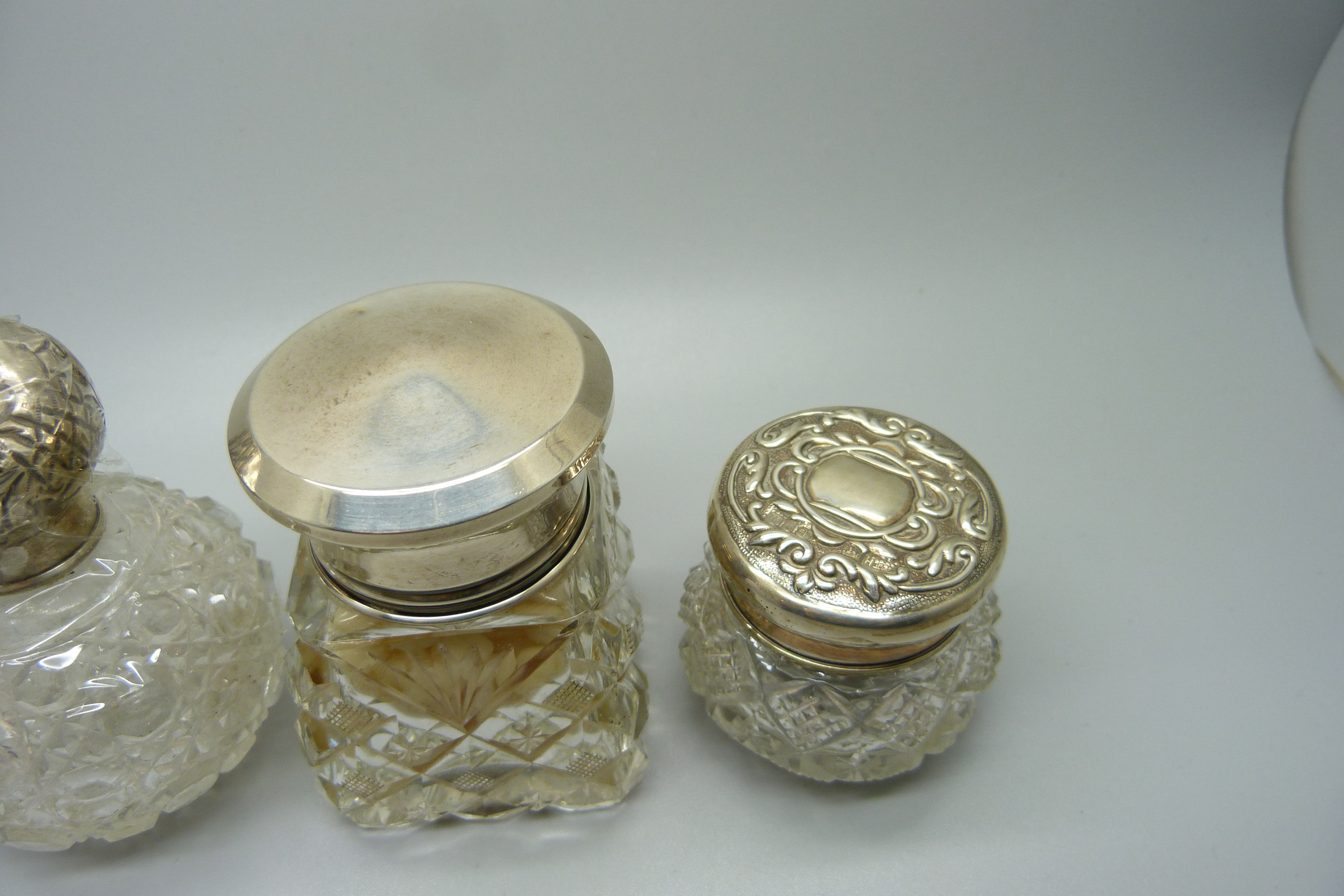 Four silver topped glass scent bottles/dressing table pots, including a scent bottle in the shape of - Image 3 of 3