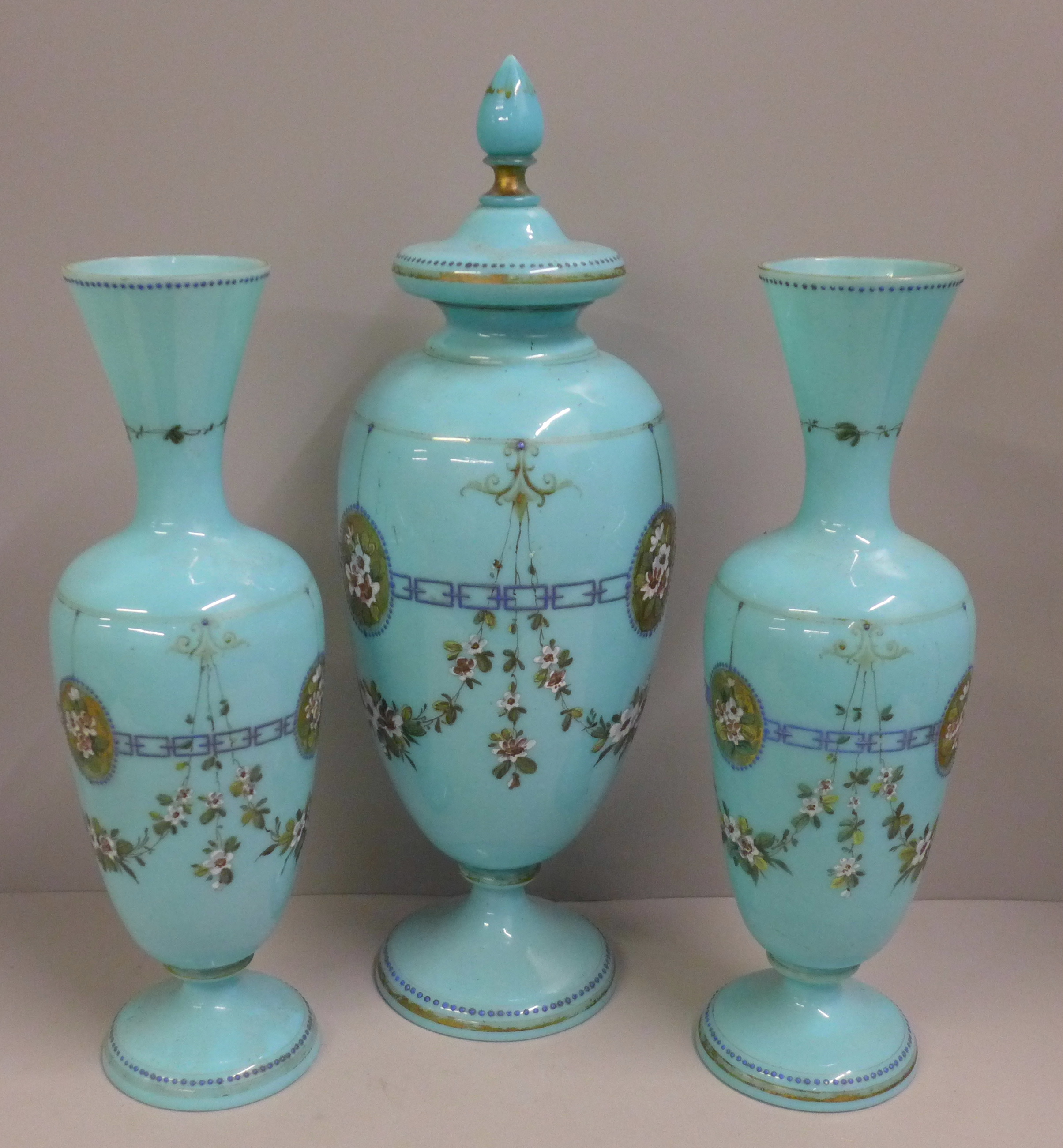 A pair of blue opaline glass vases and one taller lidded vase, enamel painted of swags of flowers - Image 2 of 6