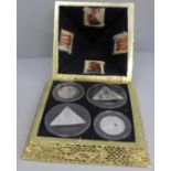 A pyramid box with four silver proof Isle of Man 2008 Tutankhamun coins, each 28g