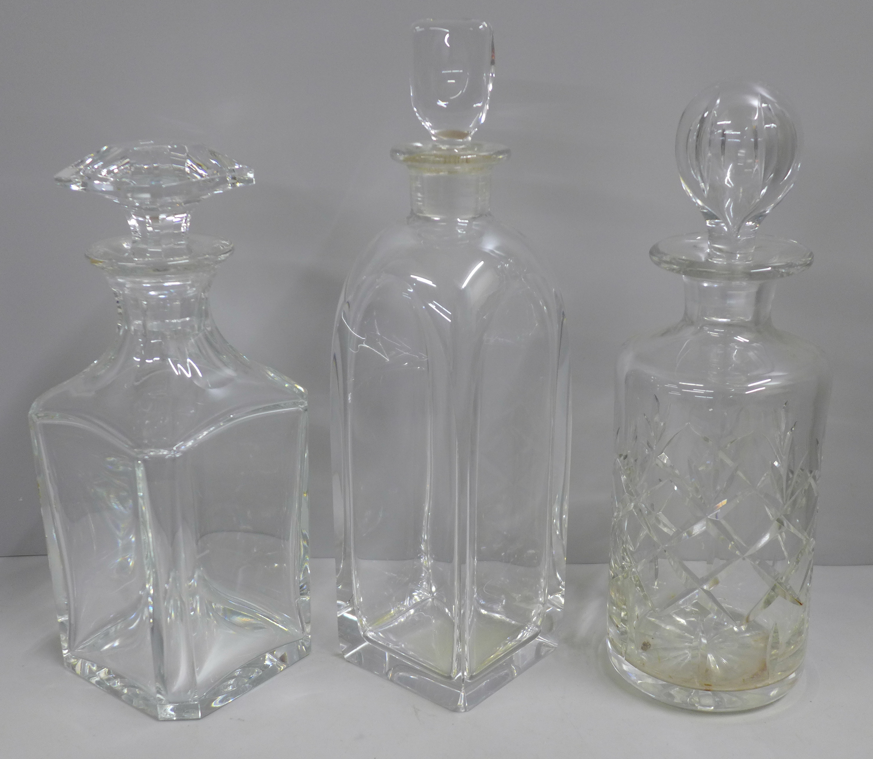 Three decanters; Baccarat, Orrefors and one other