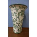 A large cream and green ceramic vase