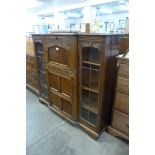 A carved oak side by side bureau bookcase (locked and without key)