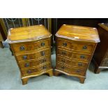 A pair of small yew wood serpentine chests of drawers