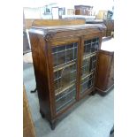 An early 20th Century carved oak two door bookcase