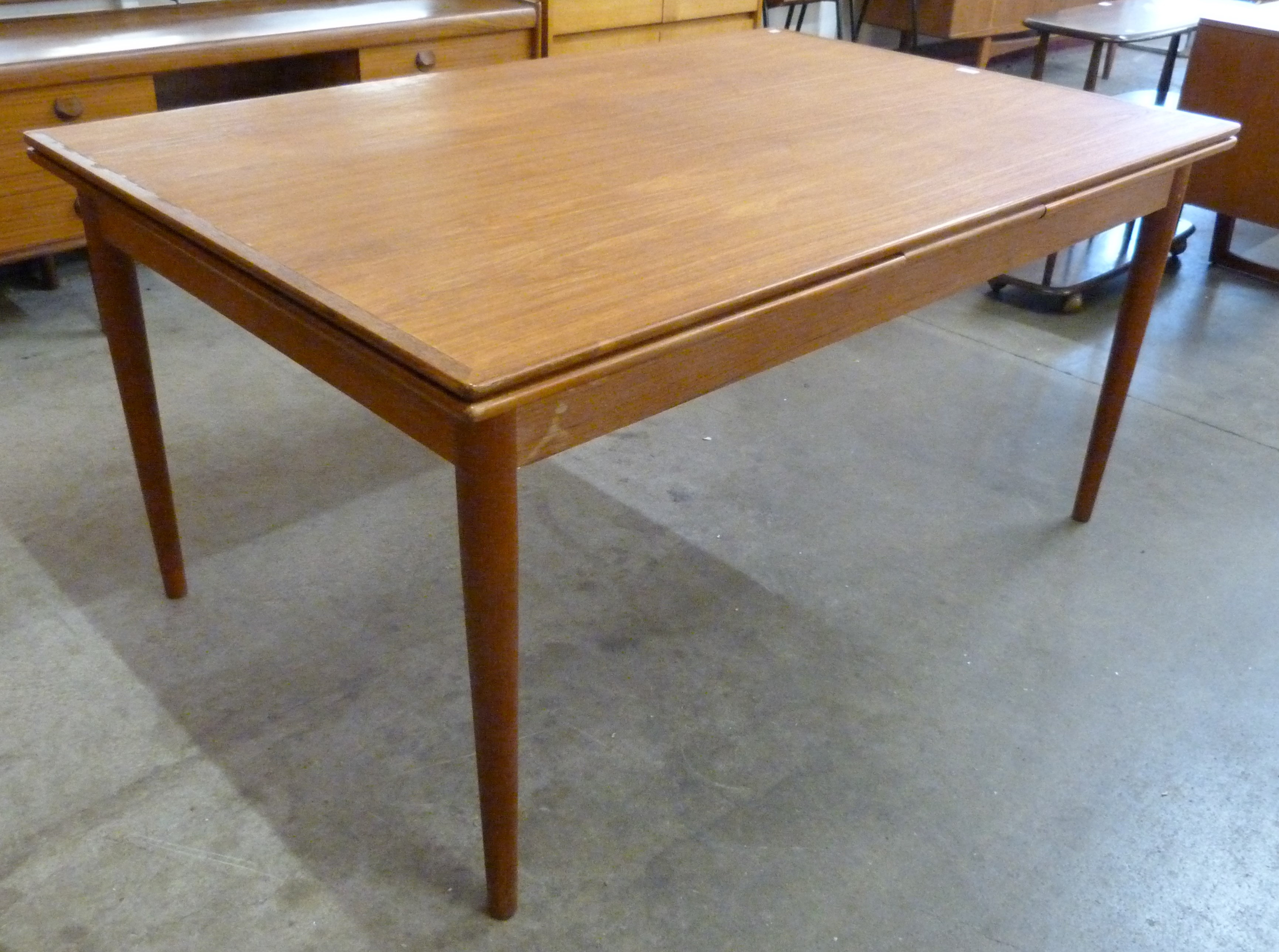 A Danish Koefoeds Hornslet teak extending dining table, designed by Niels Koefoed