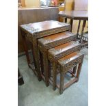 An oriental carved hardwood nest of quartetto tables