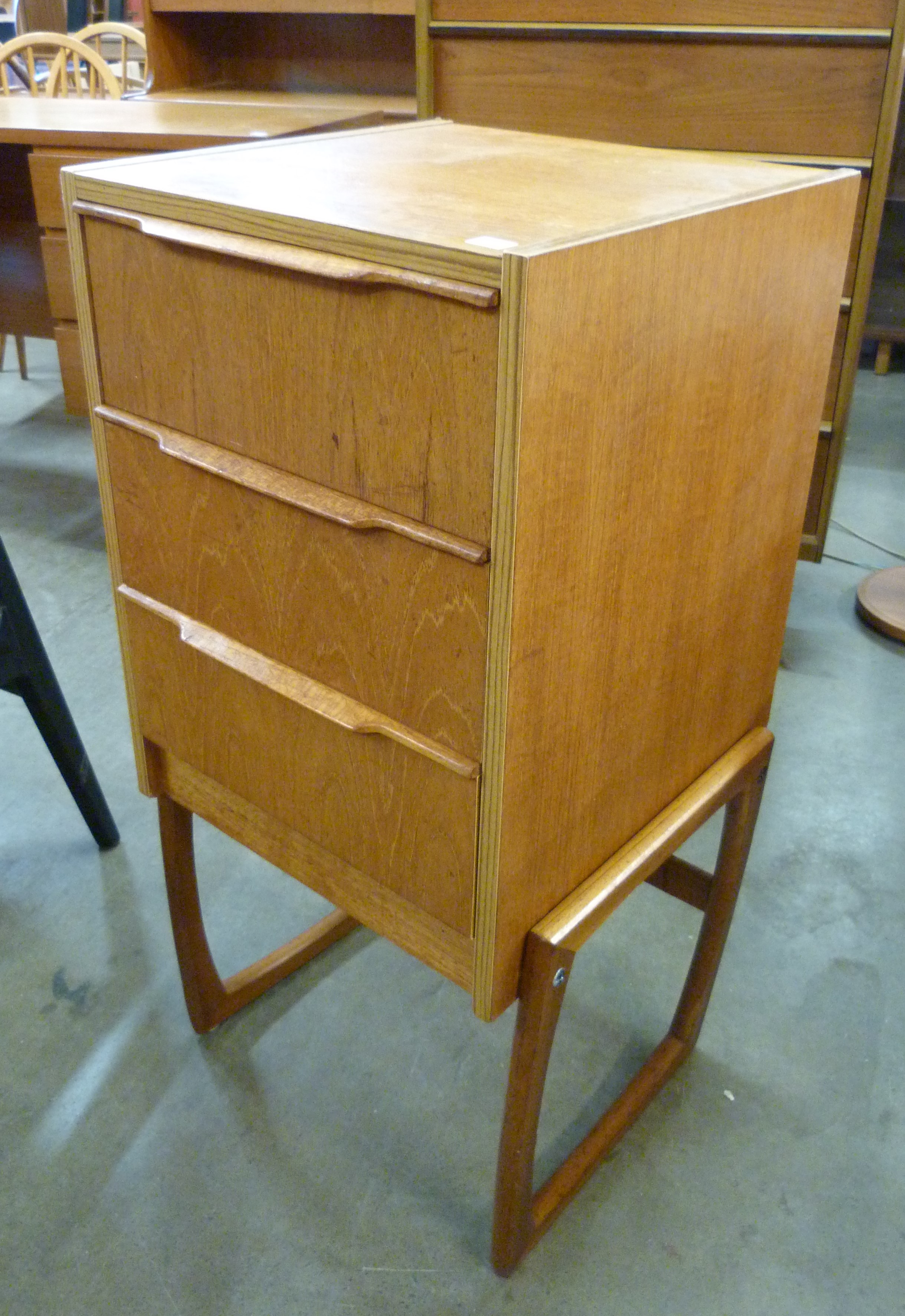 A small teak chest of drawers