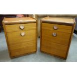 A pair of teak bedside cabinets