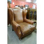 A Laura Ashley Regency style chestnut brown leather wingback armchair