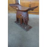 An African carved hardwood elephant based stool