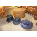 A hat box including a top hat, bowler hat and others