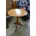 A Victorian walnut circular tilt-top tripod occasional table