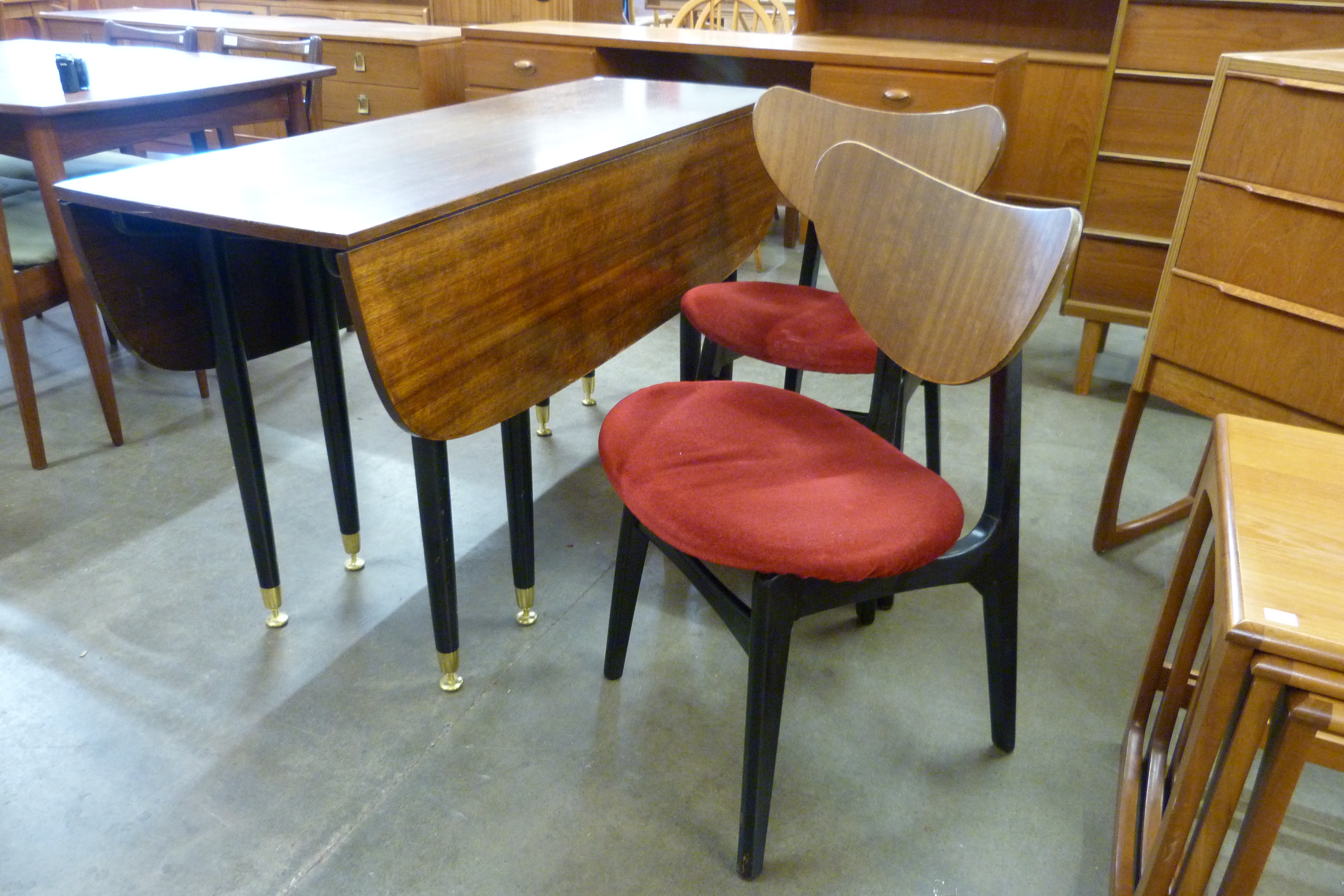 A G-Plan Librenza tola wood and black drop-leaf dining table and two chairs