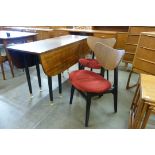 A G-Plan Librenza tola wood and black drop-leaf dining table and two chairs