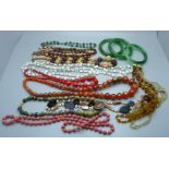 A collection of vintage jewellery including three bangles and bead necklaces