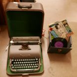 A Remington Quiet-Writer portable typewriter, cased and a box of 7" singles **PLEASE NOTE THIS LOT