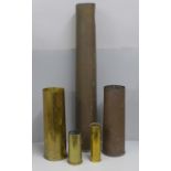 Five brass shell cases including one large