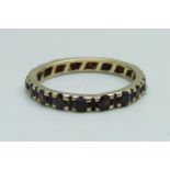 A 9ct gold and garnet eternity ring, 1.9g, O