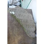 A part section of a sandstone slab with Latin inscription