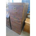 An oak four drawer filing cabinet