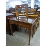 An Arts and Crafts oak two drawer side table and a book rack