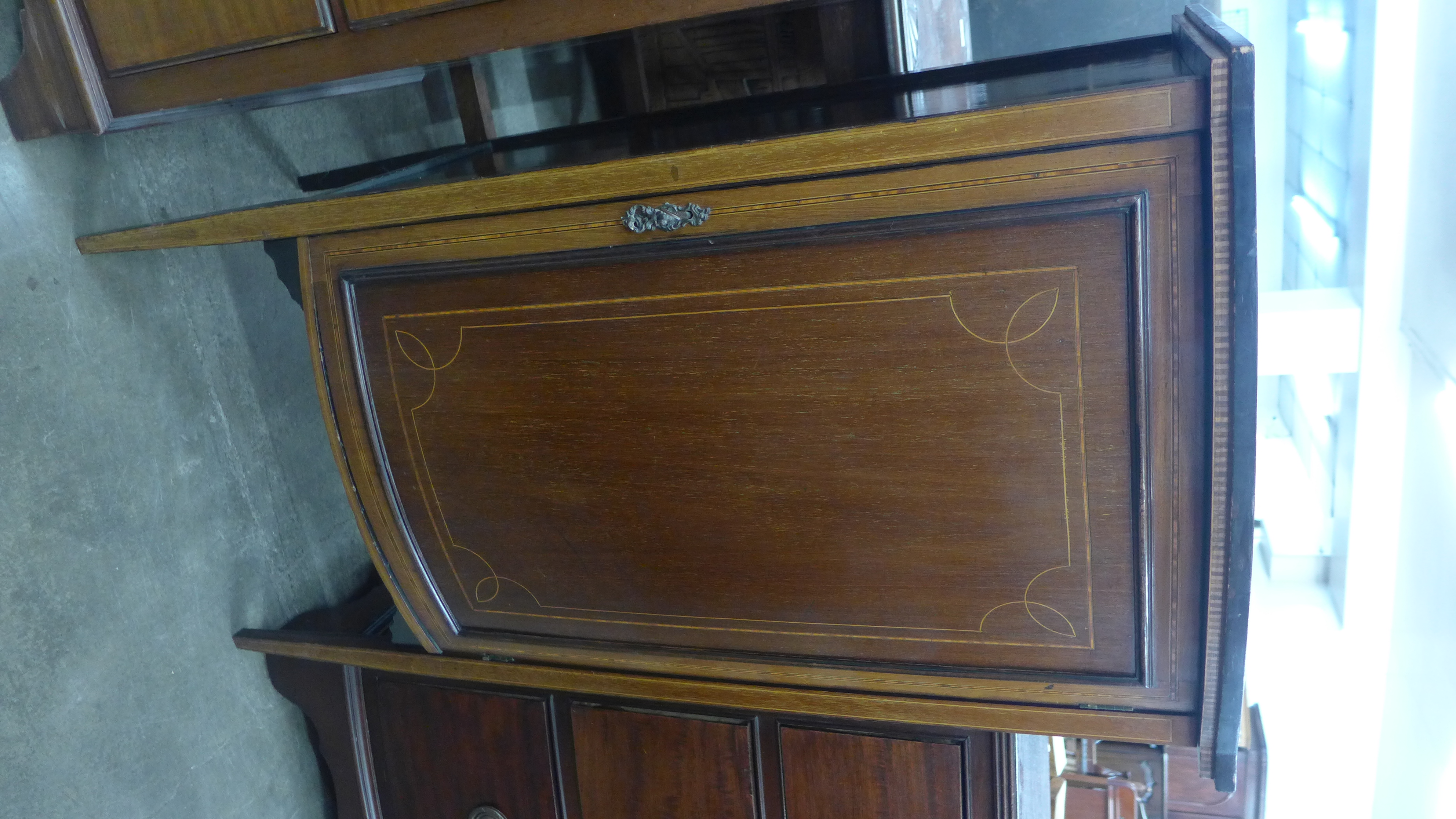 An Edward VII inlaid mahogany bow front side cabinet