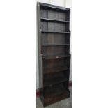 A tall early 20th Century oak waterfall front open bookcase