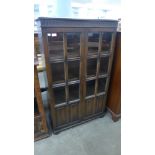 A carved oak linenfold two door bookcase