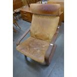 A beech and tan leather cantilever armchair