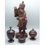 Treen including a hand carved figure of a Chinese fisherman, 24cms, and three hardwood turned lidded