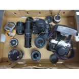 A collection of cameras and camera equipment, lenses, etc.