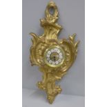 A heavy cast brass wall timepiece, 34cm