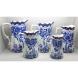 A set of five graduated Doulton Burslem blue and white jugs