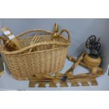 A collection of wooden items in a wicker basket including salad servers, decorative items etc. **