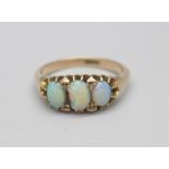 A 9ct gold and three stone opal ring, centre stone chipped, 4.1g, R