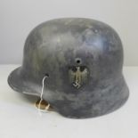 A German WWII M35 helmet shell with original paint under post war decal and paint, lot 4516