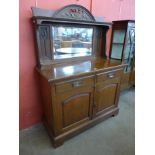 An Arts and Crafts carved oak mirrorback sideboard