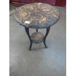 An Arts and Crafts Liberty & Co. carved ebonised Japanese range occasional table