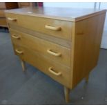 A teak chest of drawers