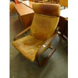 A beech and tan leather cantilever armchair