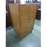 A teak chest of drawers