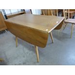 An Ercol Blonde elm and beech Windsor drop leaf table